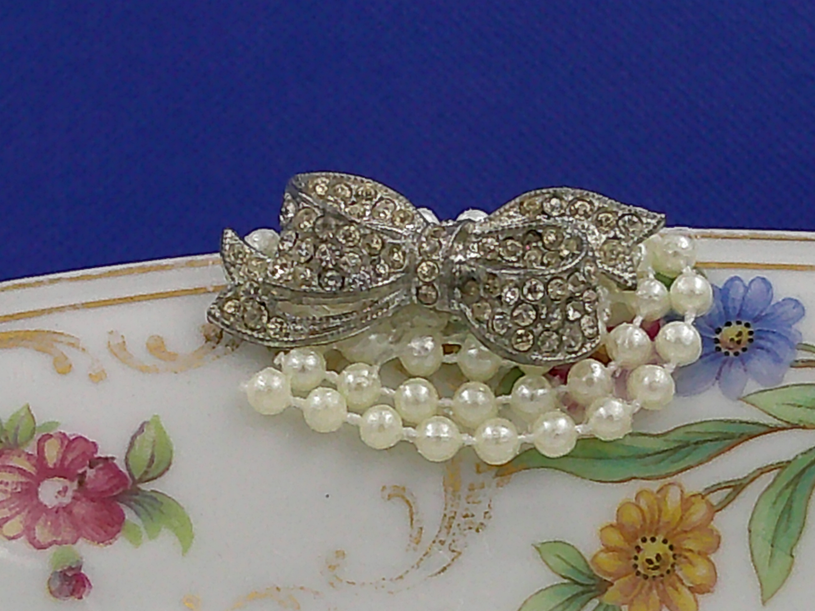 A close up of the pearls and bow button...just the right amount of bling. A close up of the pearls and bow button...just the right amount of bling.